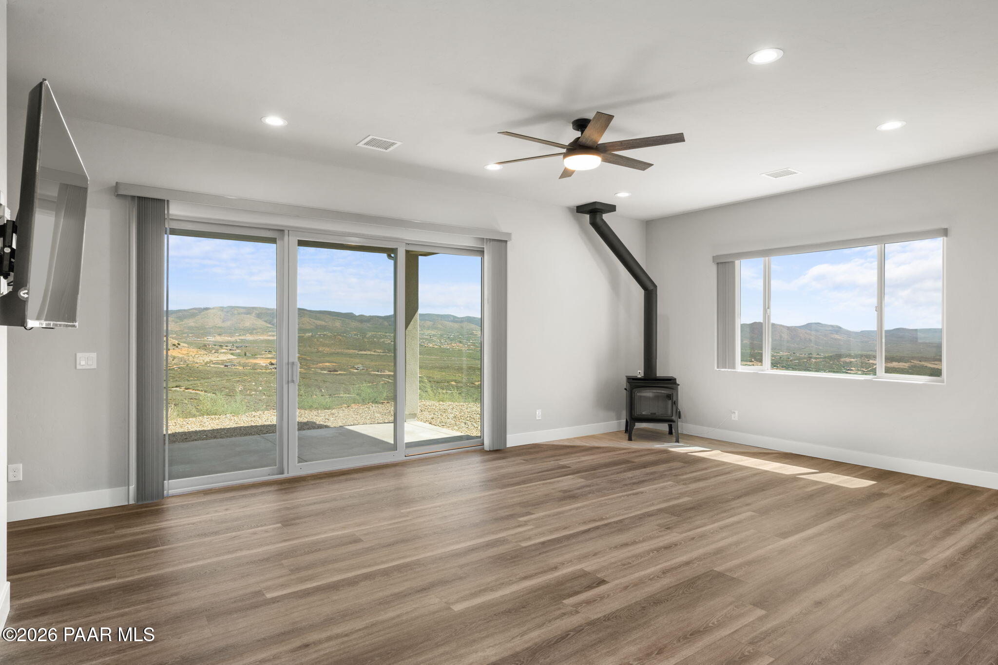 15690 East Orchard View Road Dewey, AZ 86327 - Photo 4 of 26 a view of an empty room with a window and wooden floor