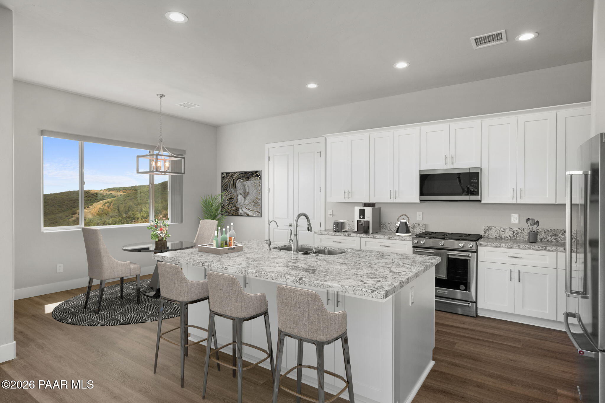 15690 East Orchard View Road Dewey, AZ 86327 - Photo 6 of 26 a kitchen with a dining table chairs and white appliances