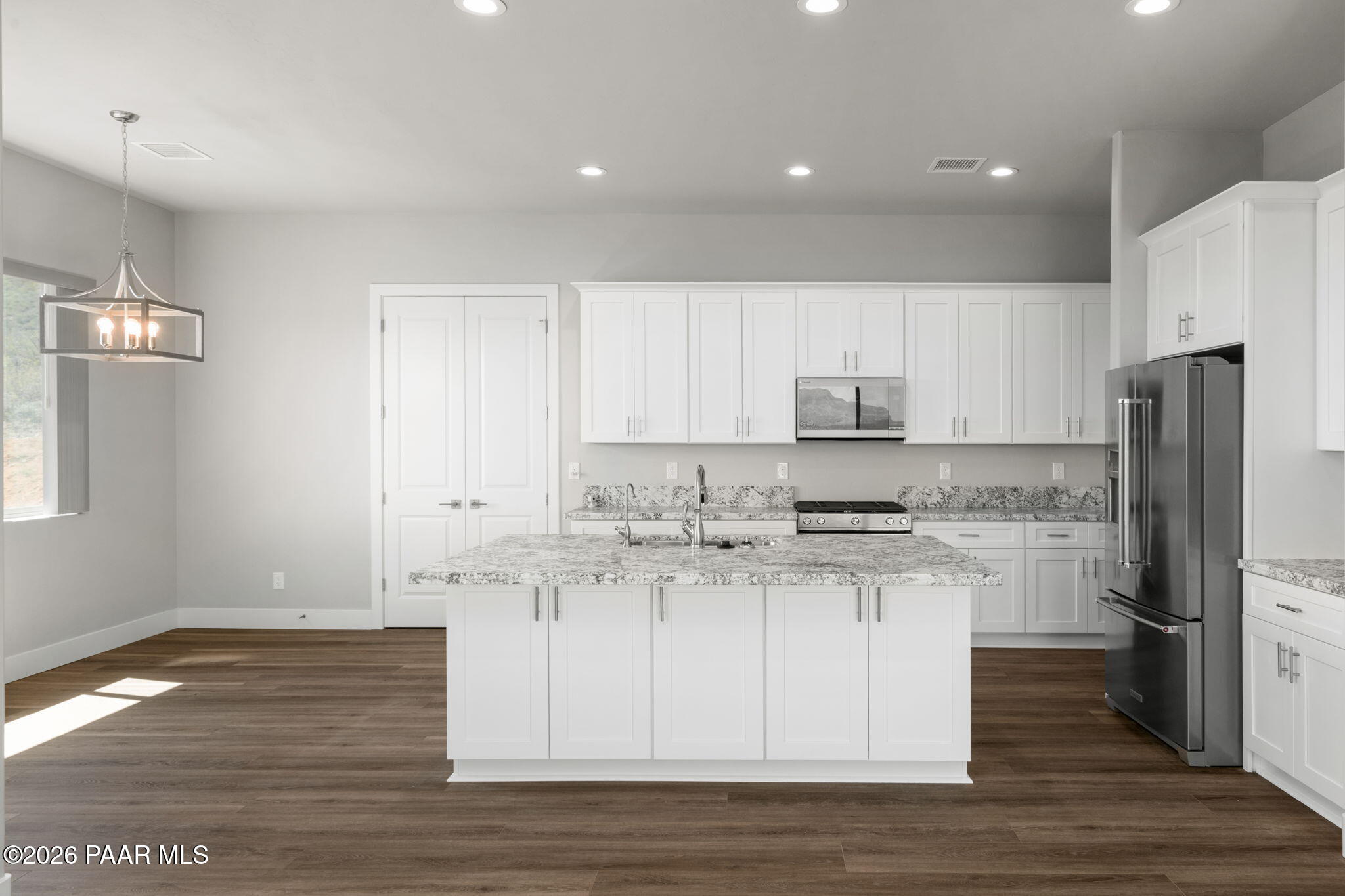 15690 East Orchard View Road Dewey, AZ 86327 - Photo 9 of 26 a kitchen with stainless steel appliances granite countertop a stove a sink and a refrigerator