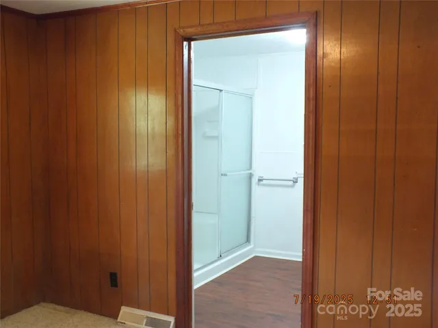 a bathroom with a glass shower door
