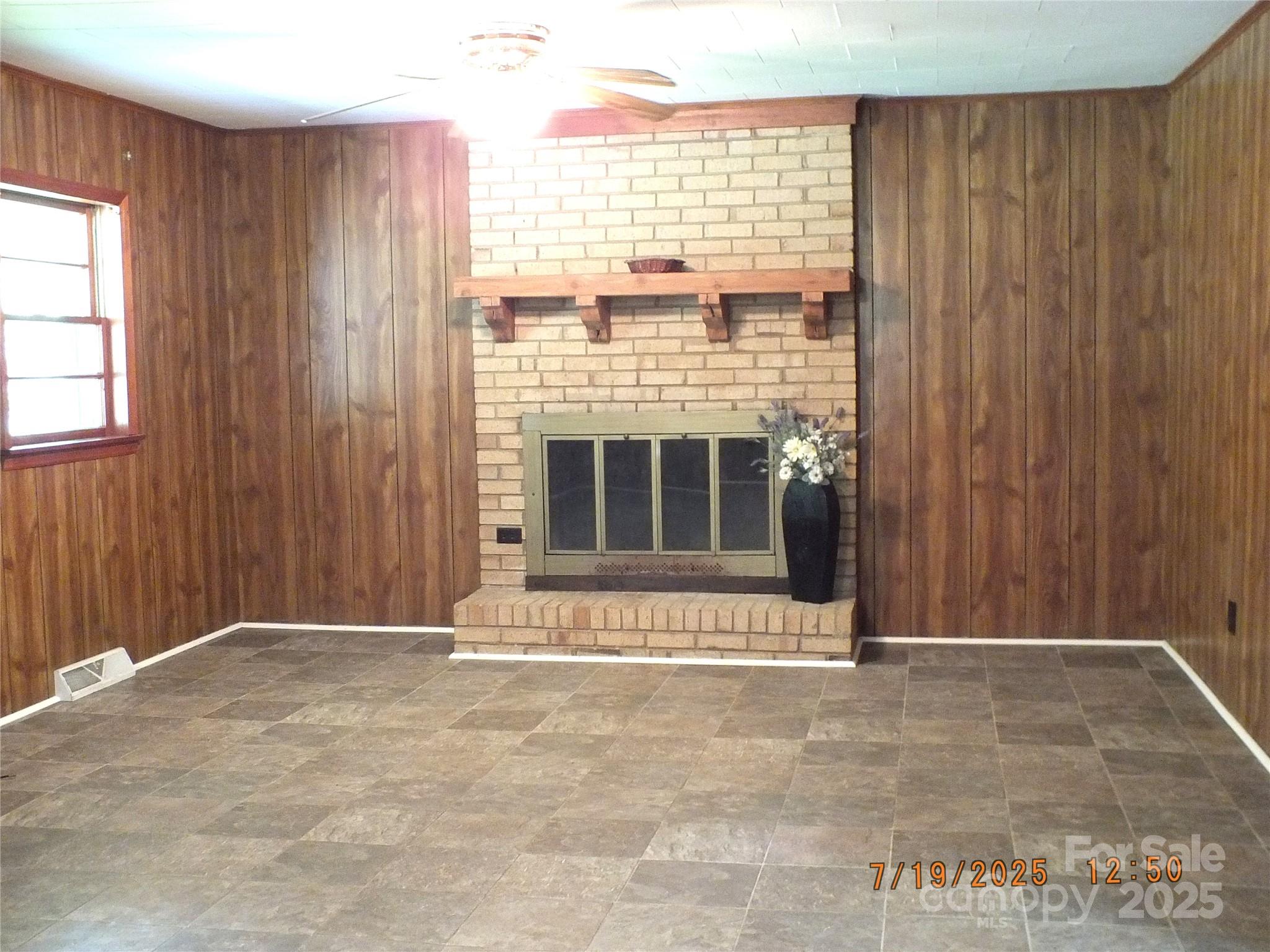 1453 Old Landsford Road Lancaster, SC 29720 - Photo 3 of 39 a view of an empty room with a fireplace and a window