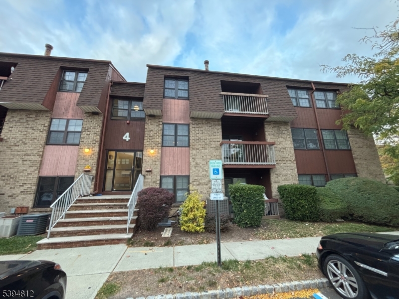 42 Powderhorn Court Woodbridge, NJ 07095 - Photo 14 of 14 a front view of a house with garden