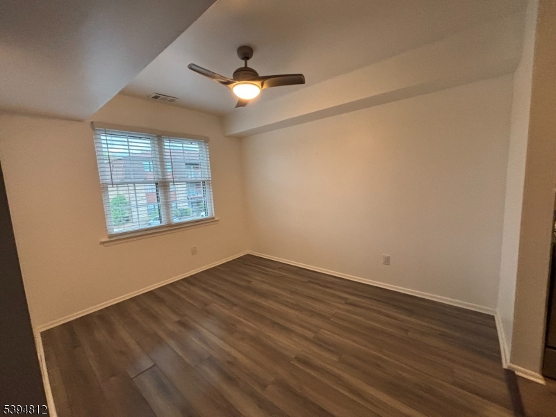 42 Powderhorn Court Woodbridge, NJ 07095 - Photo 2 of 14 an empty room with wooden floor and windows