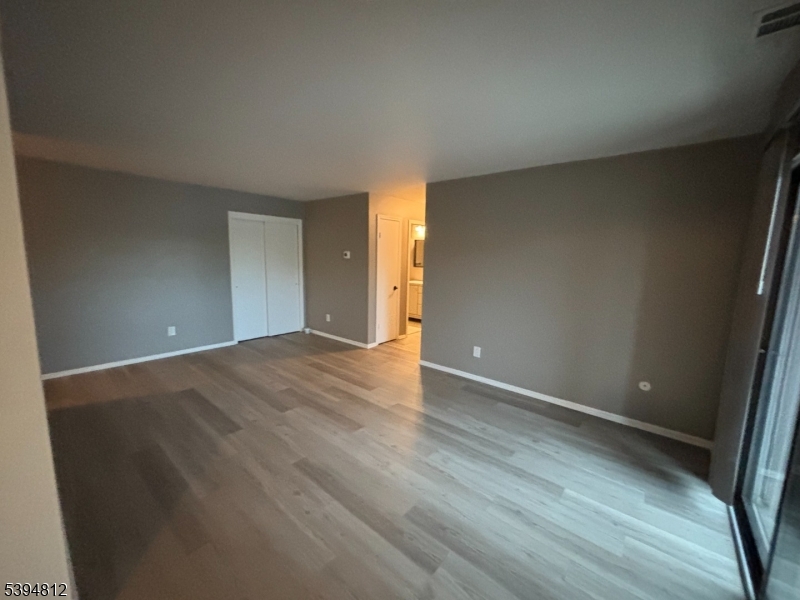 42 Powderhorn Court Woodbridge, NJ 07095 - Photo 4 of 14 a view of an empty room with wooden floor and a window
