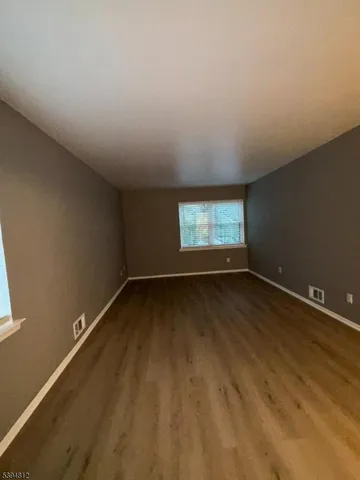 wooden floor and window in an empty room