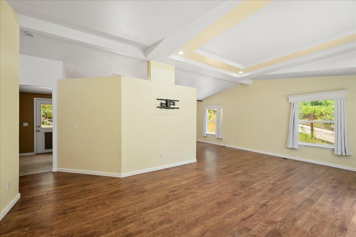 21819 Todd Valley Road Foresthill, CA 95631 - Photo 7 of 37 an empty room with wooden floor and windows