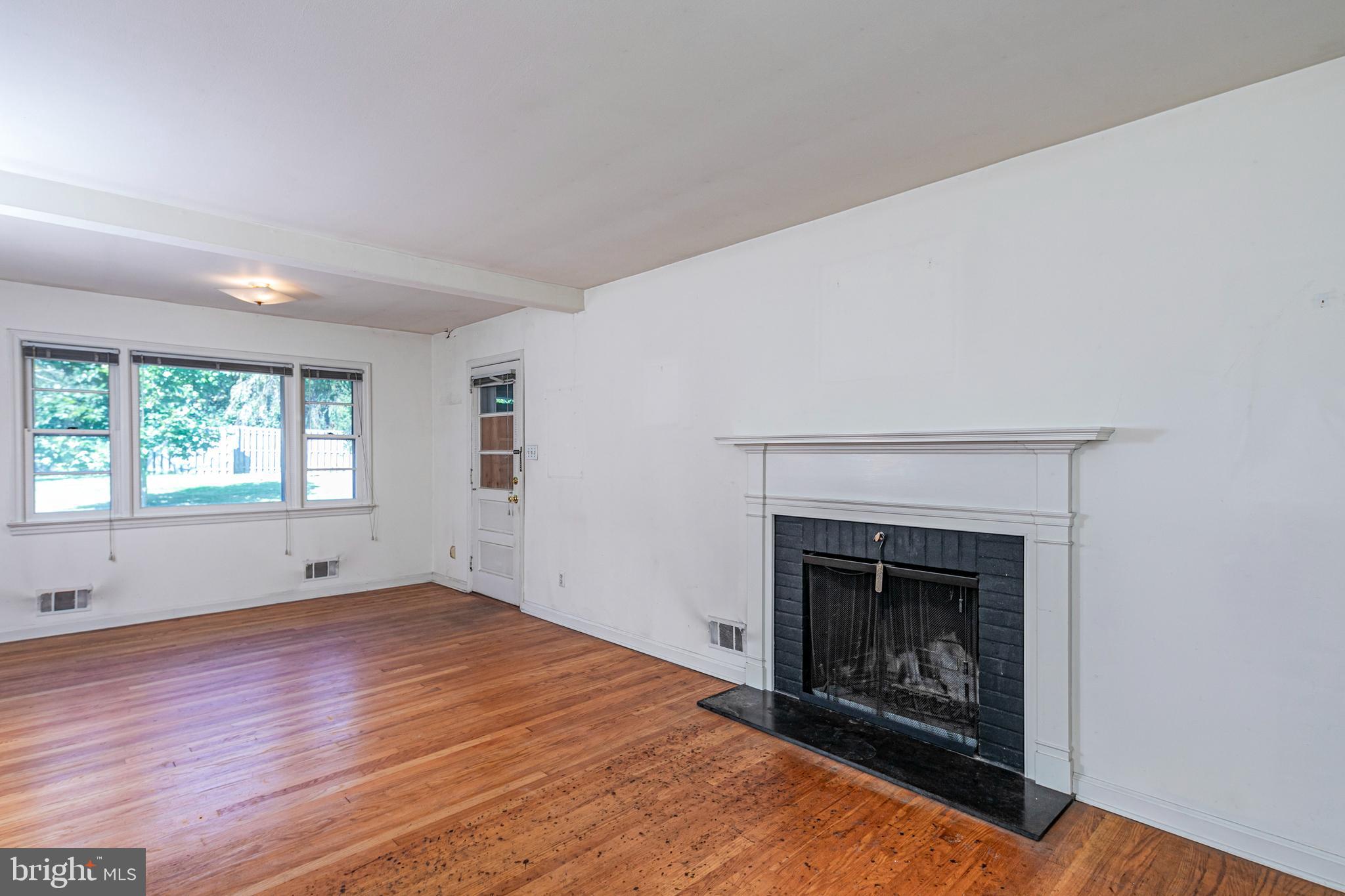 50 Broadripple Drive Princeton, NJ 08540 - Photo 5 of 17 a view of an empty room with wooden floor fireplace and a window