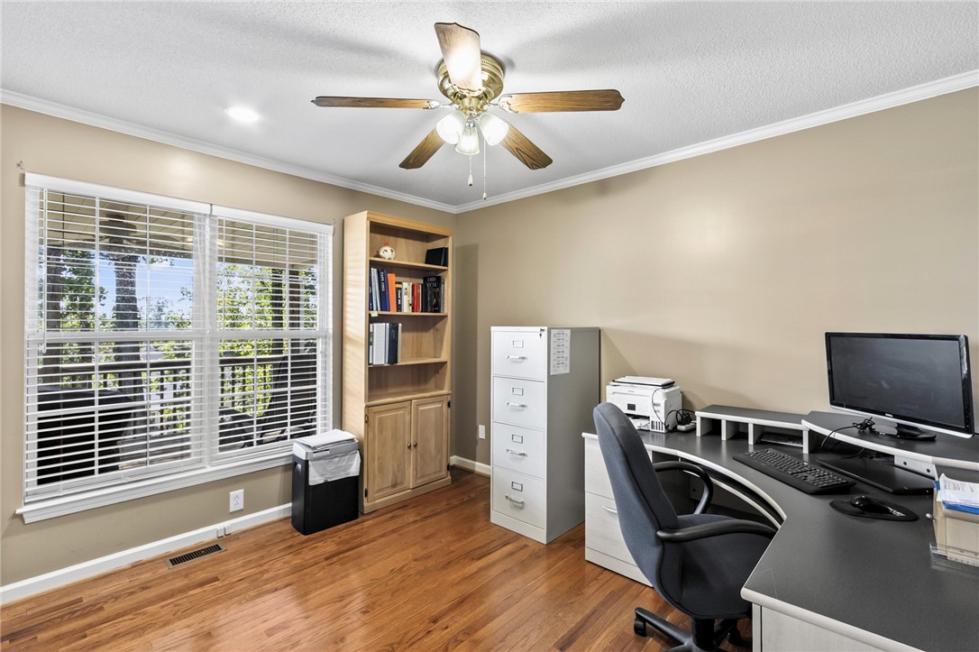608 Robin Hood Lane Anderson, SC 29621 - Photo 21 of 36 Gleaming hardwood floors and classic crown molding frame a quiet home workspace.