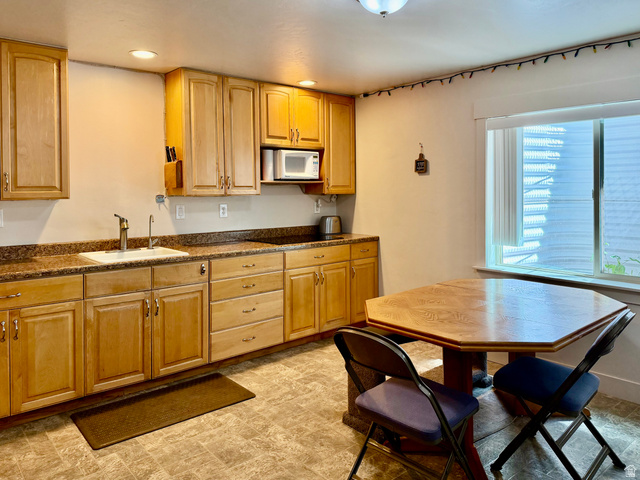 1204 South 1150th Street West Payson, UT 84651 - Photo 11 of 26 Basement Kitchen featuring wood cabinetry, stone-finish countertops, and a stainless steel sink with a gooseneck faucet