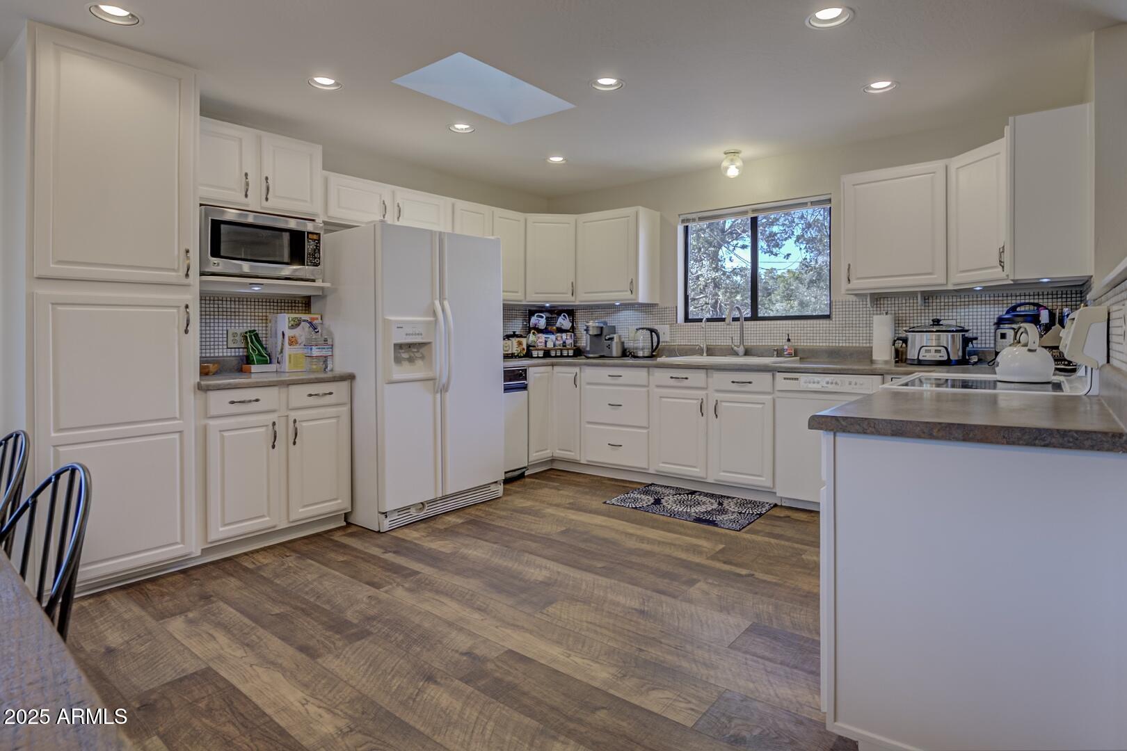 4823 Rim View Loop Pine, AZ 85544 - Photo 20 of 70 a kitchen with white cabinets and appliances