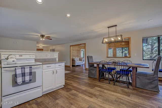 a bedroom with a large bed a chandelier and a window