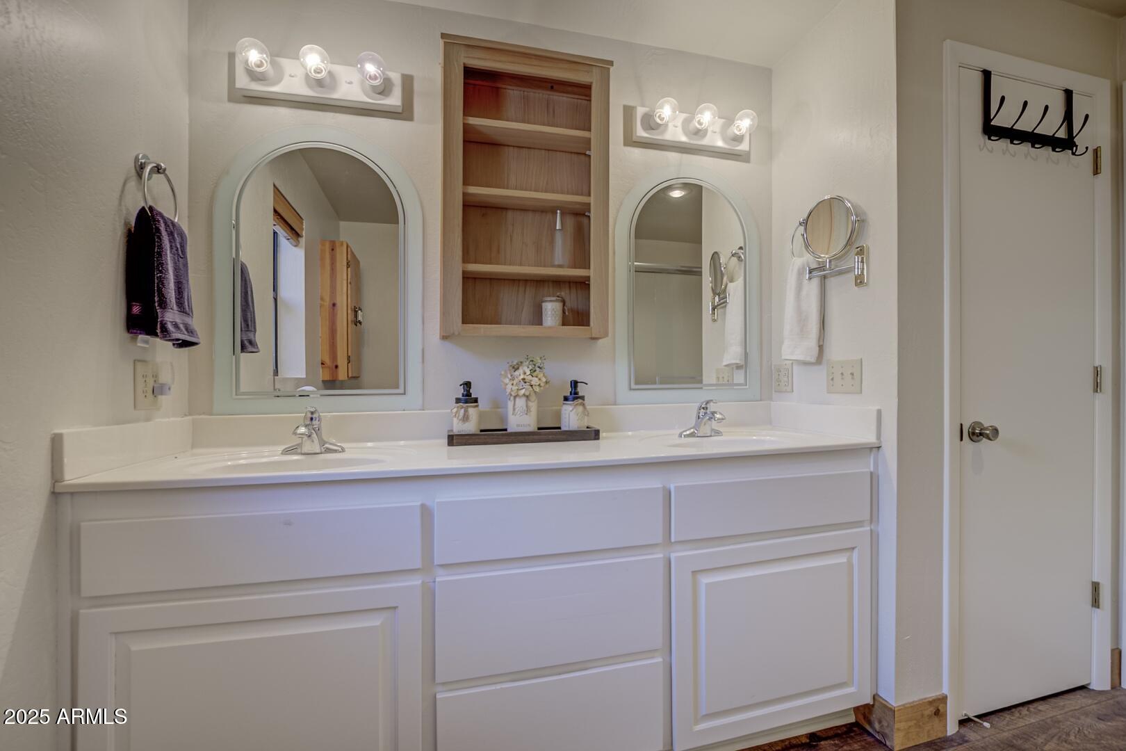 4823 Rim View Loop Pine, AZ 85544 - Photo 34 of 70 a bathroom with double vanity sinks a vanity and a mirror