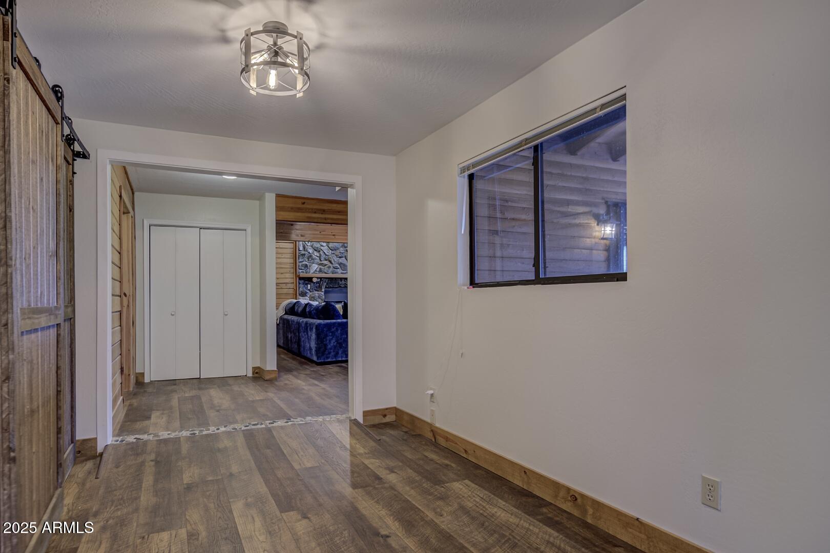4823 Rim View Loop Pine, AZ 85544 - Photo 38 of 70 a view of a livingroom with wooden floor and a ceiling fan