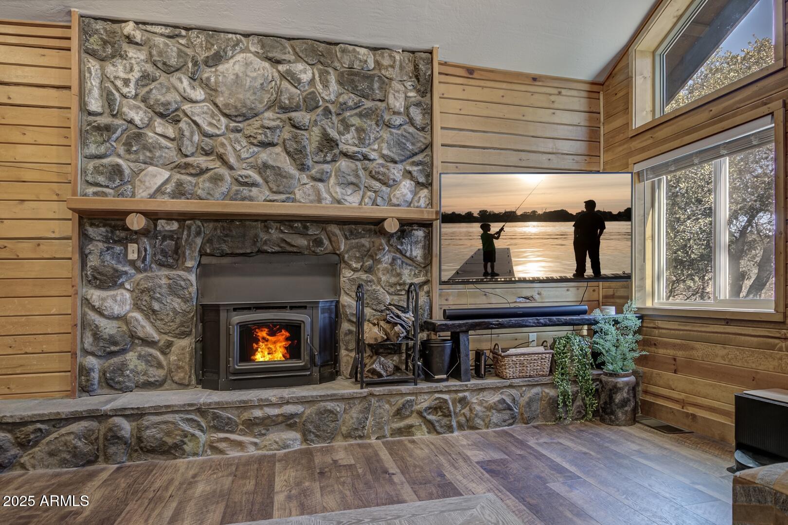4823 Rim View Loop Pine, AZ 85544 - Photo 45 of 70 a living room with a fireplace and windows