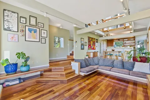 a living room with furniture and painting on the wall