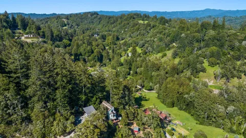 an aerial view of a residential houses with green space