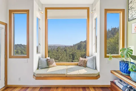a living room with a large window and table