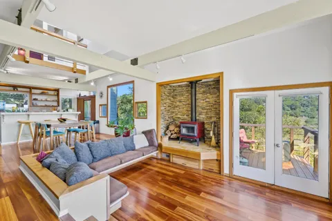 a living room with furniture and a floor to ceiling window