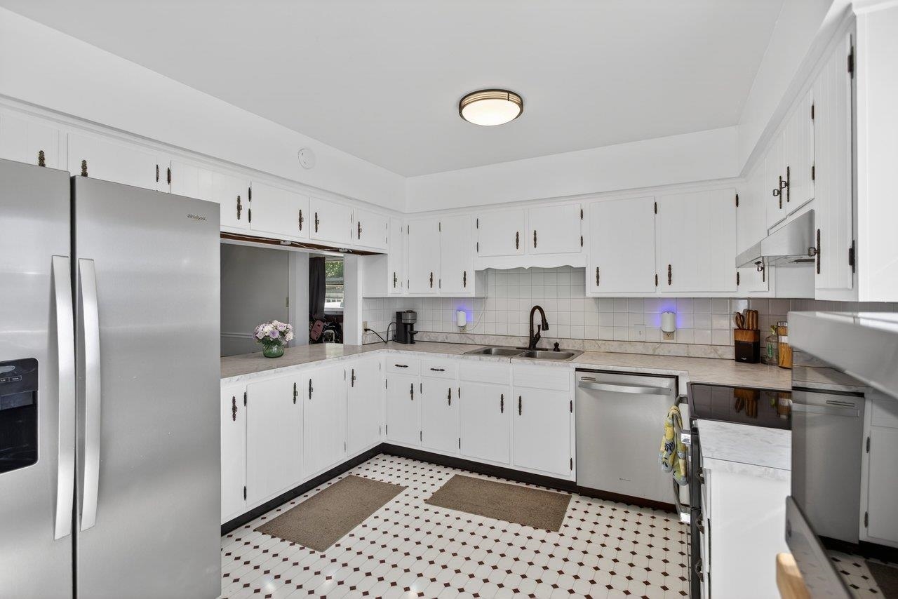 420 West Spring Street Woodstock, VA 22664 - Photo 16 of 67 a kitchen with stainless steel appliances a refrigerator sink and cabinets