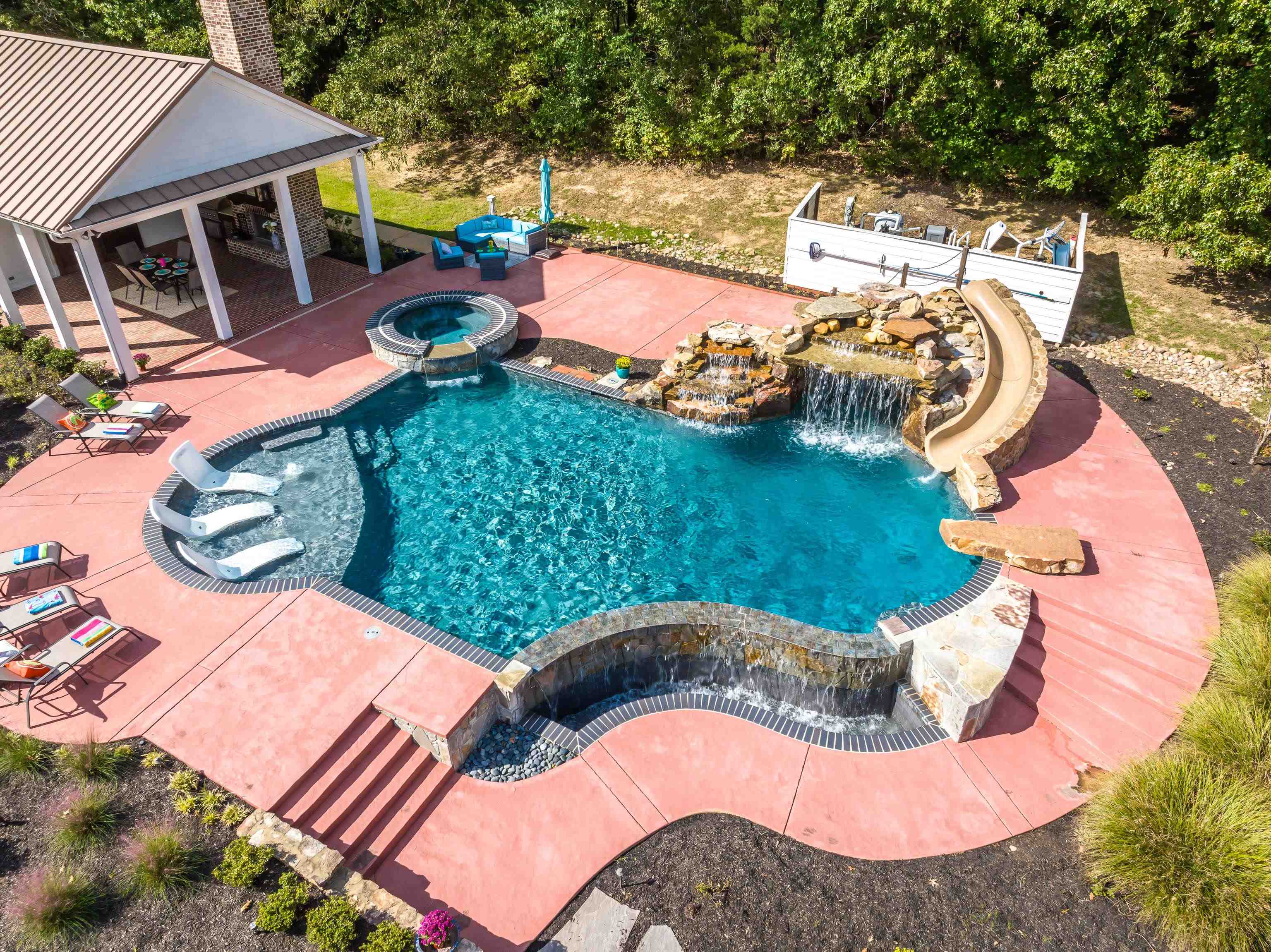 159 Lynn Road Eads, TN 38028 - Photo 29 of 40 Aerial view of the HEATED Salt Water pool and it's muti-level pool decks! The Rock Waterfall cascades down the entrance of the private grotto with seating! Get into the pool via the diving rock or the water slide tucked neatly beside the waterfall!