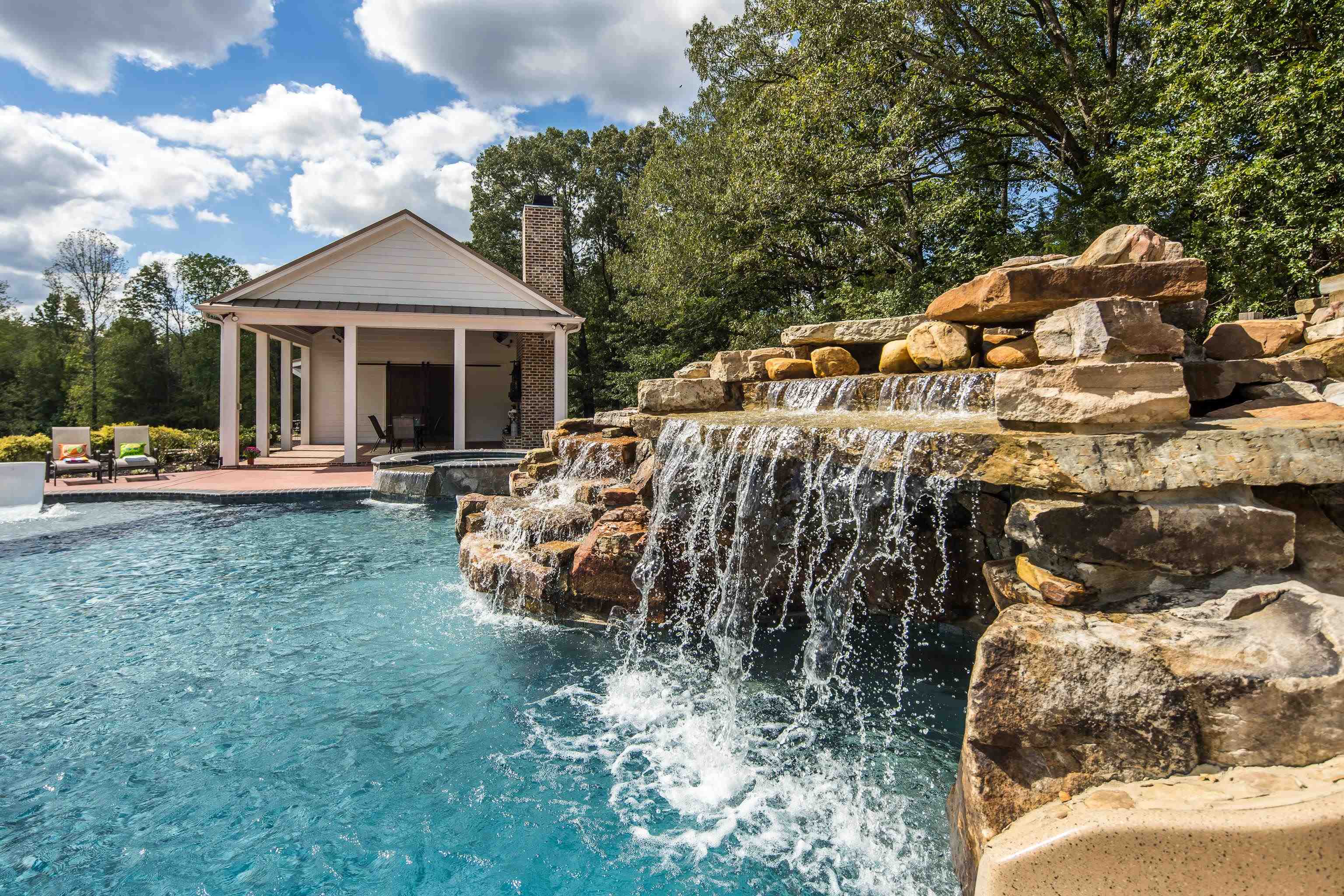 159 Lynn Road Eads, TN 38028 - Photo 31 of 40 Cascades of water flow down the entrance of the grotto and the suns reflection sparkles on the water. This isn't a seasonal pool! It's fully heated and can be enjoyed year round!