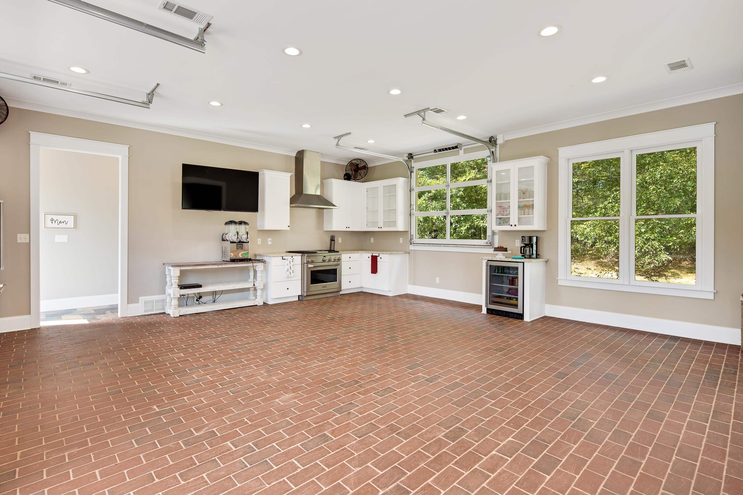 159 Lynn Road Eads, TN 38028 - Photo 36 of 40 Pool House is equipped w/ a full Commercial Kitchen IDEAL for entertaining! Complete with 2 Garage Style Glass Doors at the bar tops for serving guests at the pool. Top of the line Monogram Appliances, 4 Burner Gas Range, Scotsman Pellet Ice Maker