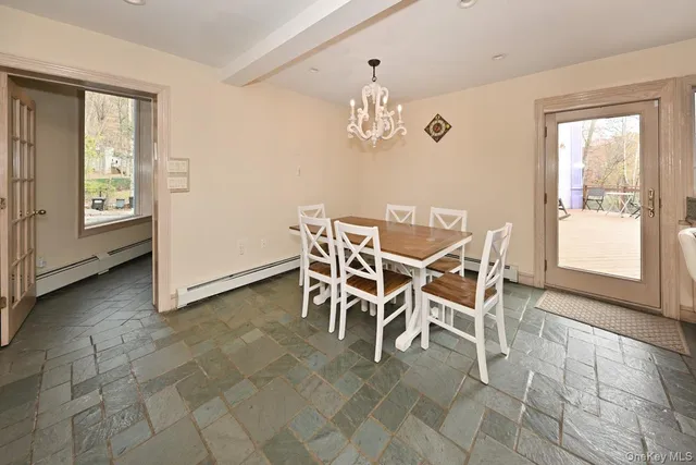 a view of a dining room with furniture and window