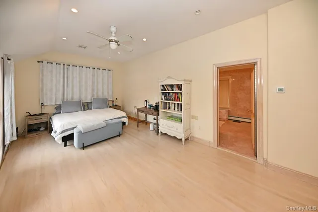 a bedroom with a bed and cabinets