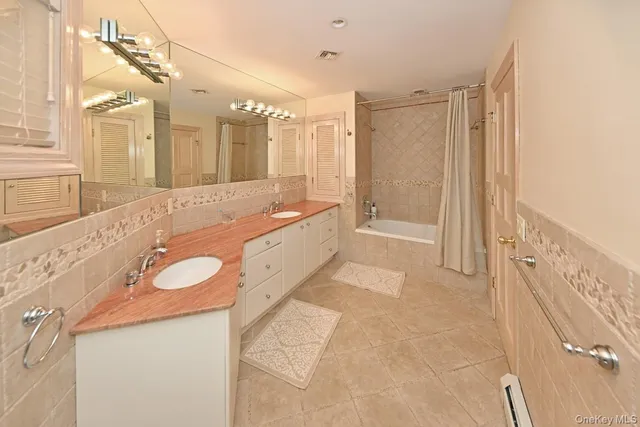 a large bathroom with a tub a sink and a mirror