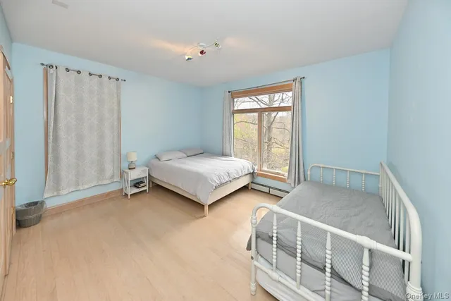 a bedroom with bed and a window