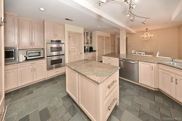 a kitchen with stainless steel appliances granite countertop a sink and cabinets