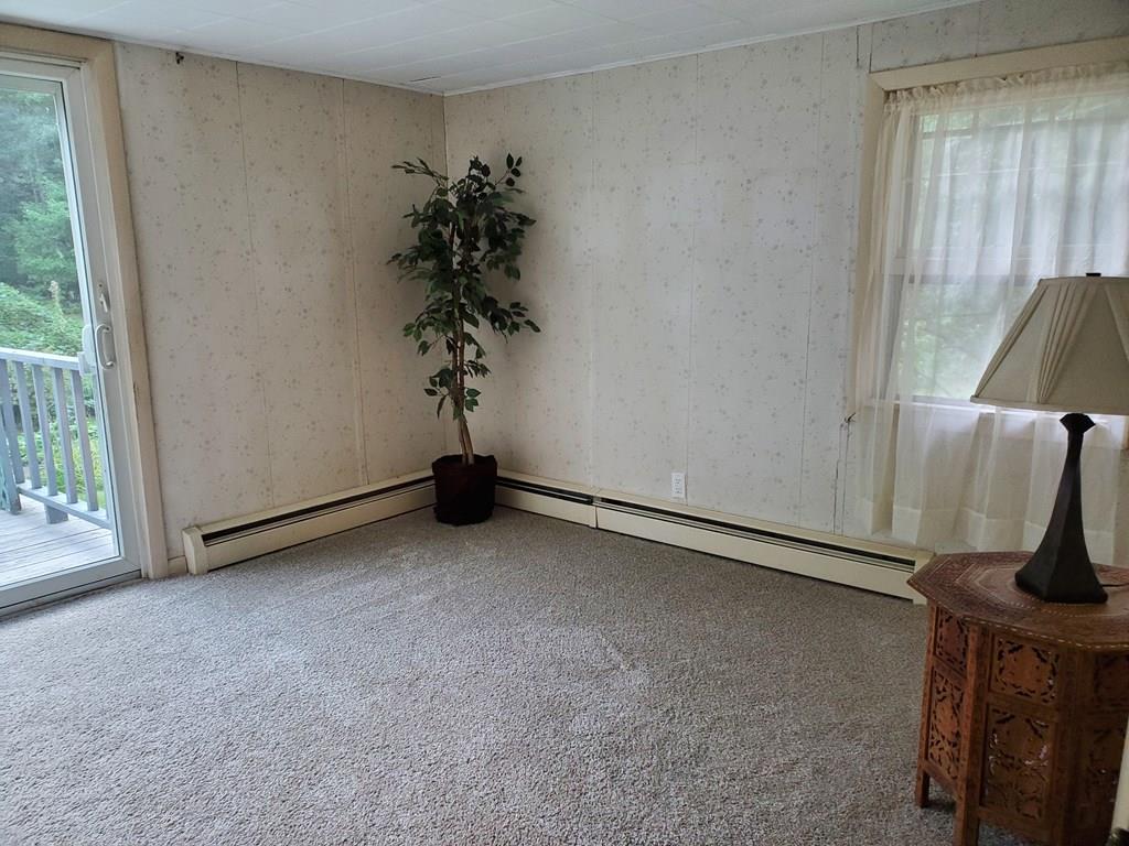 808 Patriots Road Templeton, MA 01468 - Photo 9 of 22 an empty room with windows