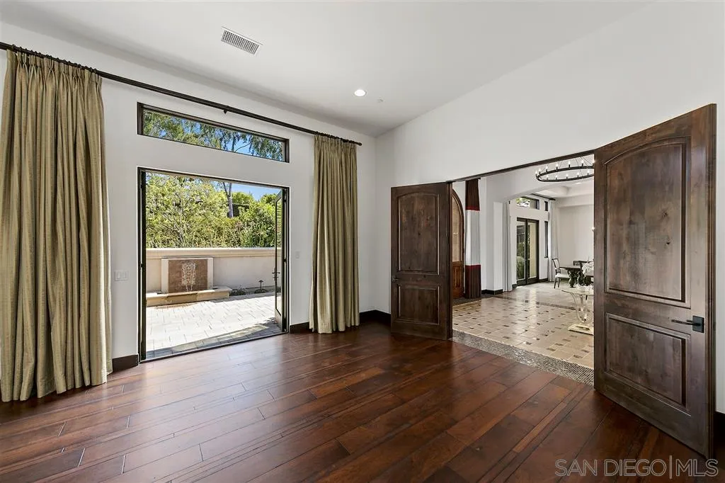 6806 St Andrews Road Rancho Santa Fe, CA 92067 - Photo 11 of 25 a view of a big room with wooden floor electronic appliances and windows