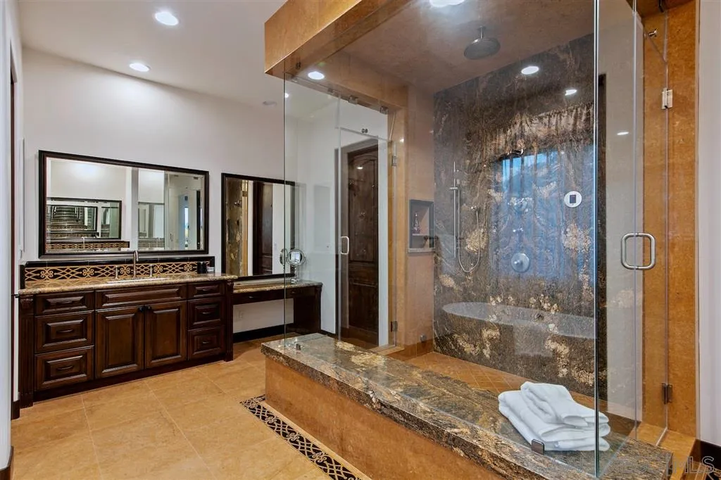 6806 St Andrews Road Rancho Santa Fe, CA 92067 - Photo 18 of 25 a bathroom with a granite countertop sink a toilet and shower