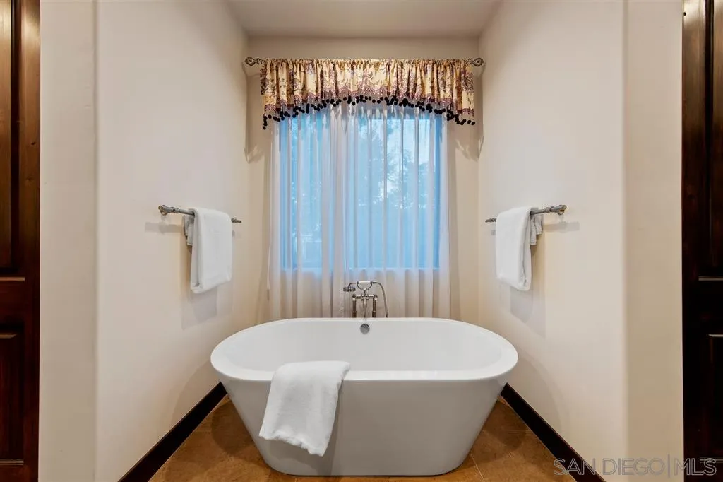 6806 St Andrews Road Rancho Santa Fe, CA 92067 - Photo 19 of 25 a white bath tub sitting in a bathroom next to a sink
