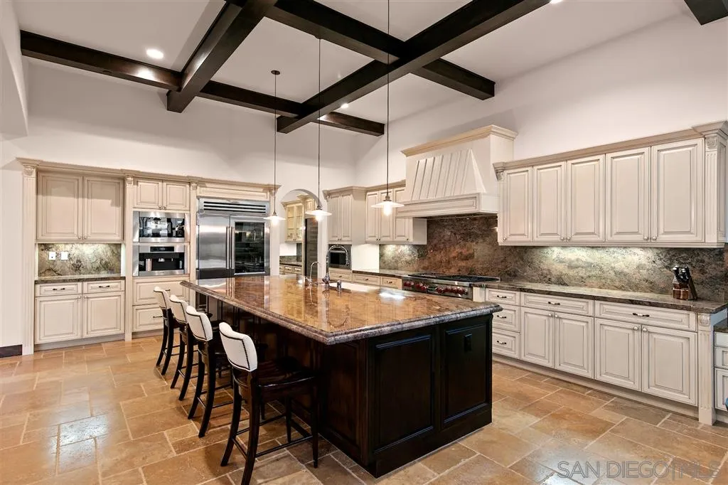 6806 St Andrews Road Rancho Santa Fe, CA 92067 - Photo 7 of 25 a dining table with chairs and cabinets