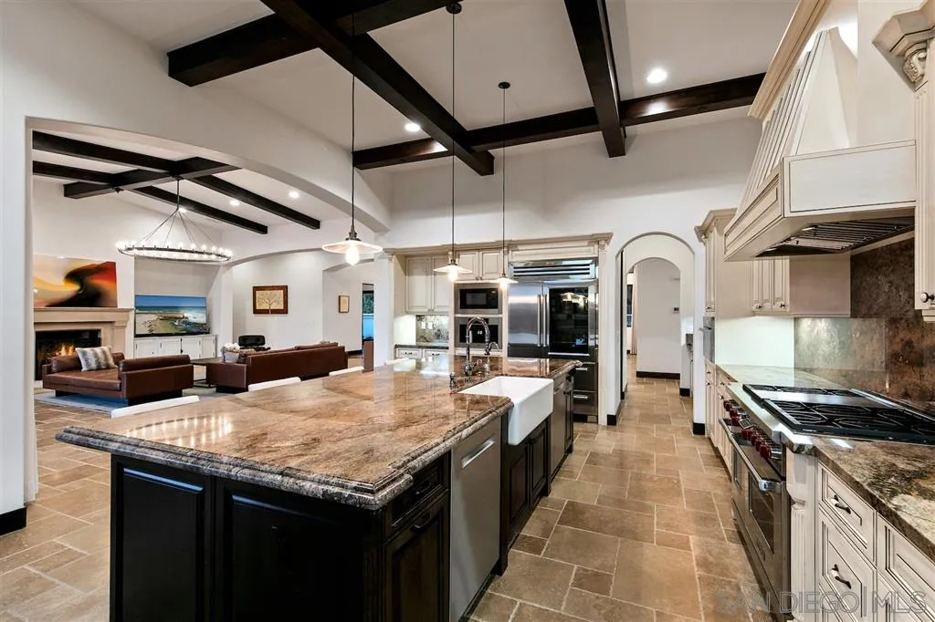 6806 St Andrews Road Rancho Santa Fe, CA 92067 - Photo 8 of 25 a kitchen with counter top space and stainless steel appliances