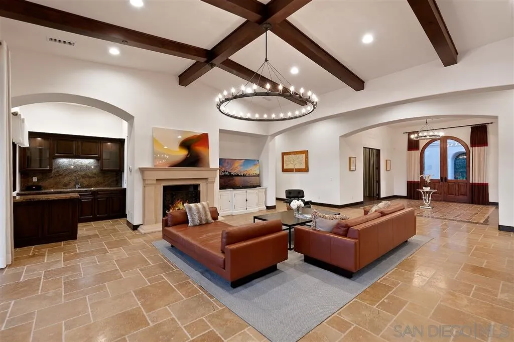 6806 St Andrews Road Rancho Santa Fe, CA 92067 - Photo 9 of 25 a living room with furniture a fireplace and a flat screen tv