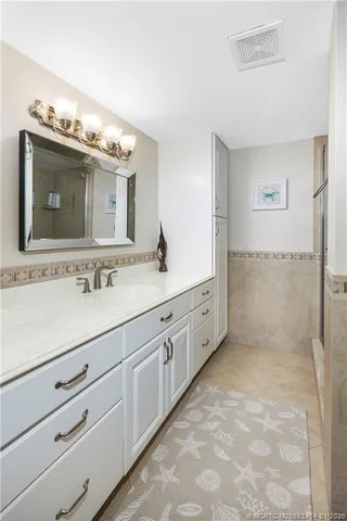 a bathroom with double sink and a mirror