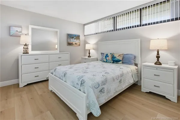 a bedroom with a large bed and a dresser