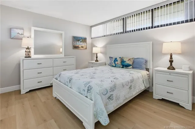 a bedroom with a large bed and a dresser
