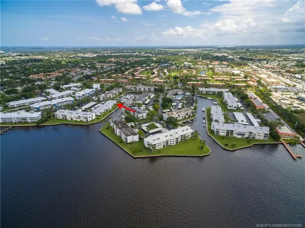 an aerial view of residential houses with outdoor space and swimming pool