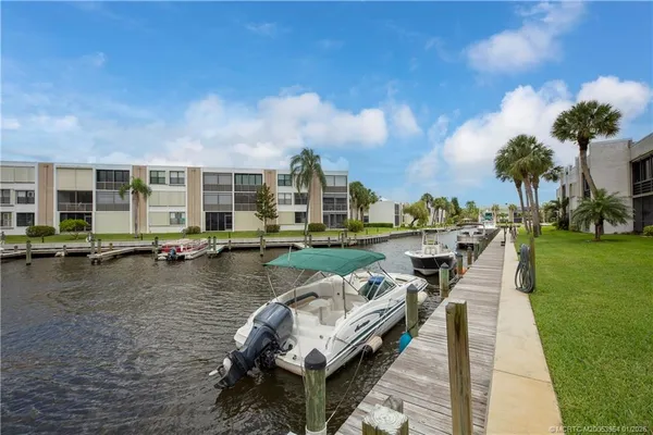 a view of a city with lawn chairs and large trees