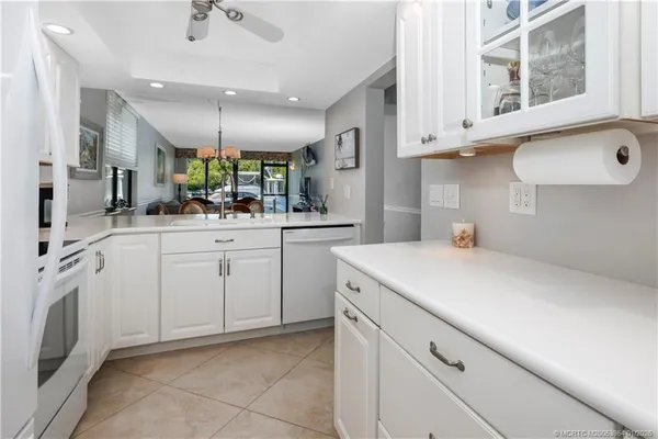 a kitchen with white cabinets and white appliances
