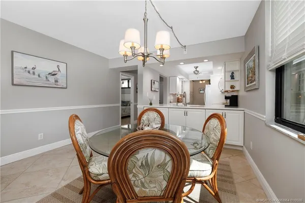 a view of a dining room with furniture and chandelier