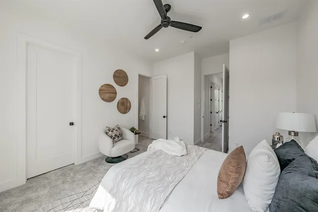 a bedroom with a large bed and a chandelier