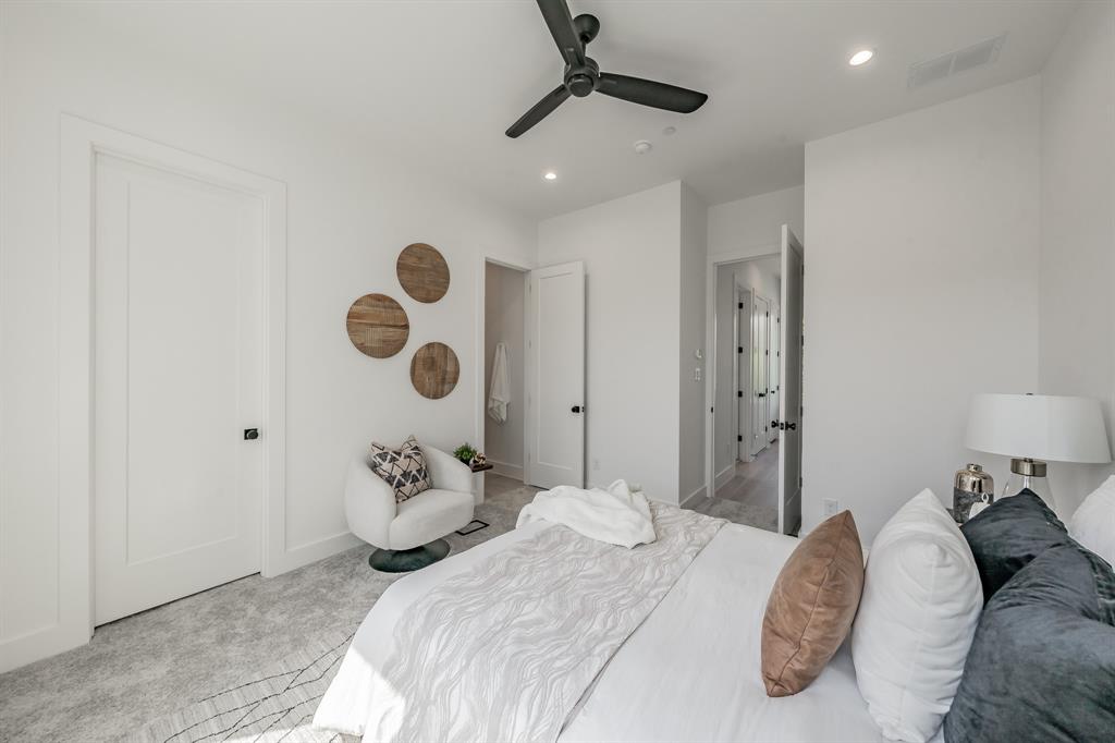 5320 Reiger Avenue, Unit 103 Dallas, TX 75214 - Photo 15 of 29 a bedroom with a large bed and a chandelier