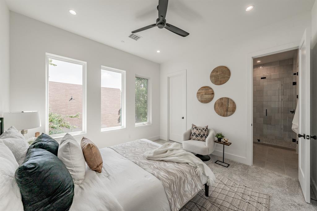 5320 Reiger Avenue, Unit 103 Dallas, TX 75214 - Photo 16 of 29 a bedroom with a large bed and a chandelier