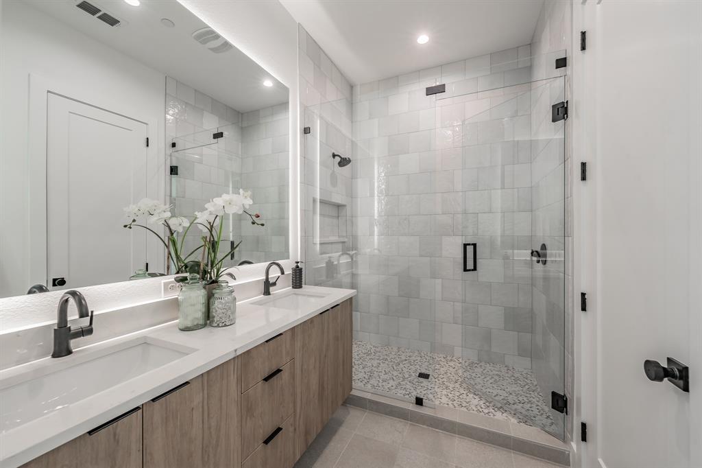 5320 Reiger Avenue, Unit 103 Dallas, TX 75214 - Photo 17 of 29 a bathroom with a double vanity sink mirror and shower