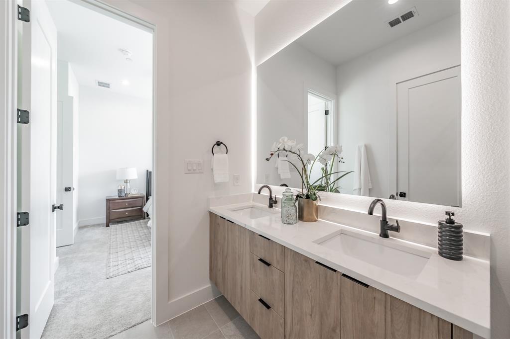 5320 Reiger Avenue, Unit 103 Dallas, TX 75214 - Photo 18 of 29 a bathroom with a double vanity sink and a mirror